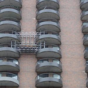 Building with balconies being worked on
